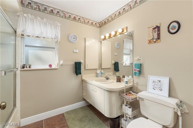 full bathroom featuring vanity, combined bath / shower with glass door, tile patterned floors, and toilet