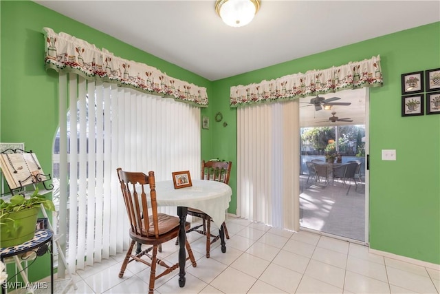 tiled dining space featuring ceiling fan