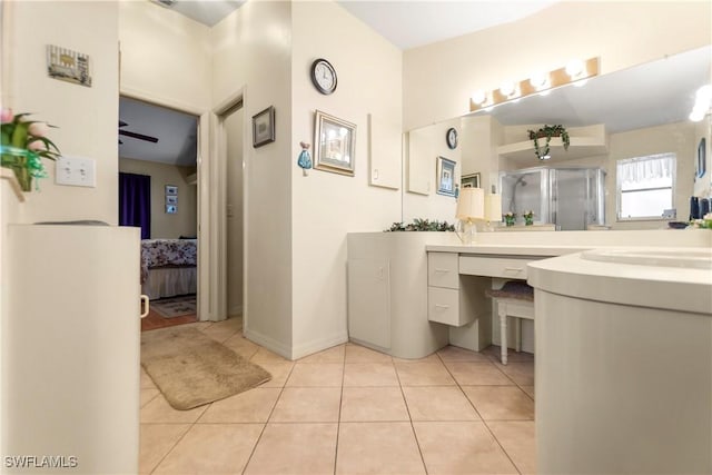 bathroom featuring tile patterned flooring, vanity, ceiling fan, and walk in shower