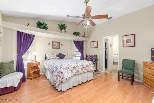 bedroom with vaulted ceiling, ceiling fan, and light hardwood / wood-style floors