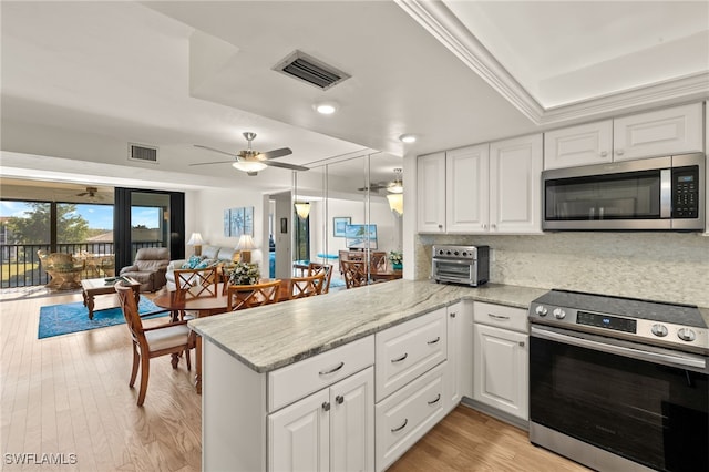 kitchen with white cabinetry, stainless steel appliances, and kitchen peninsula