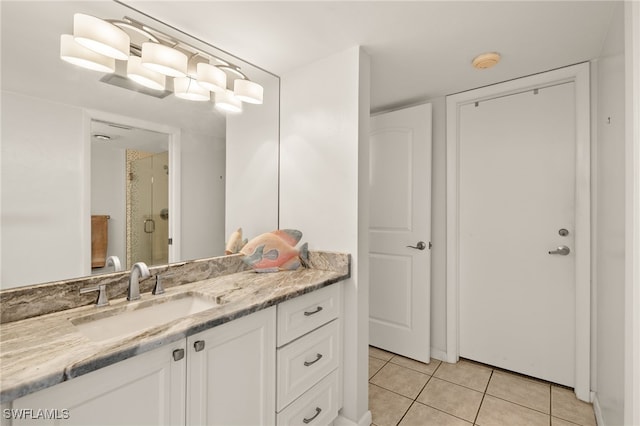 bathroom with vanity, tile patterned flooring, and a shower