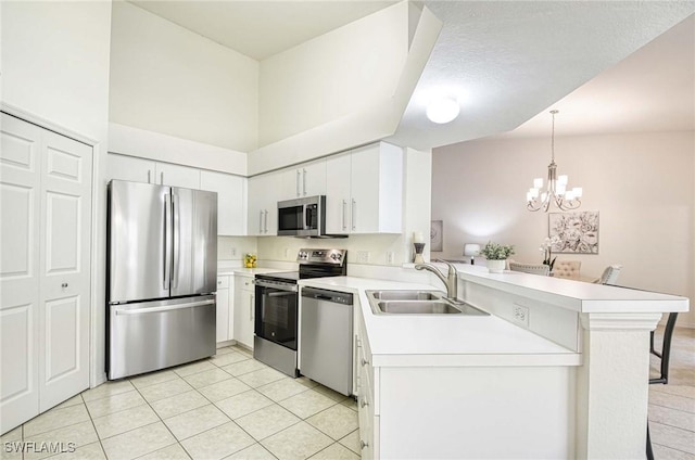 3260 Douglas Dr Unit 204, Naples, FL 34105 - kitchen with a sink, stainless steel appliances, light tile patterned floors, a peninsula, and light countertops