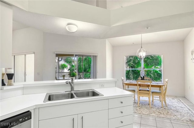 3260 Douglas Dr Unit 204, Naples, FL 34105 - kitchen featuring plenty of natural light, light tile patterned floors, light countertops, dishwasher, and a sink