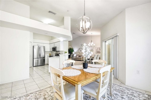 3260 Douglas Dr Unit 204, Naples, FL 34105 - dining area with lofted ceiling, light tile patterned floors, visible vents, and a notable chandelier