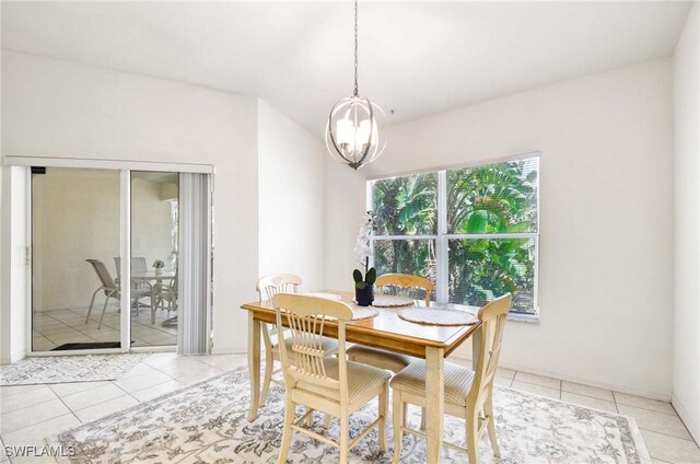 3260 Douglas Dr Unit 204, Naples, FL 34105 - dining area featuring light tile patterned floors and an inviting chandelier