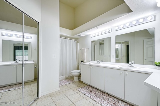 3260 Douglas Dr Unit 204, Naples, FL 34105 - bathroom featuring toilet, tile patterned flooring, double vanity, and a sink