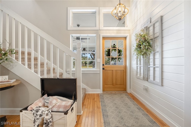 foyer entrance featuring an inviting chandelier and light wood-type flooring