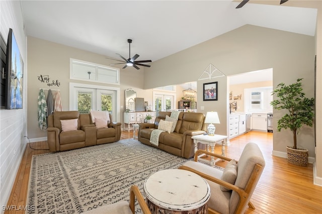 living room featuring high vaulted ceiling, french doors, ceiling fan, and light wood-type flooring