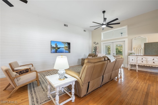 living room featuring light hardwood / wood-style flooring, french doors, and ceiling fan