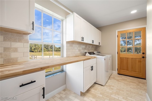 laundry room with cabinets and washing machine and clothes dryer