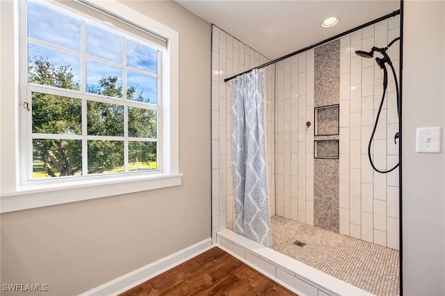 bathroom featuring hardwood / wood-style floors and a shower with shower curtain