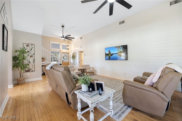 living room featuring light hardwood / wood-style floors and ceiling fan