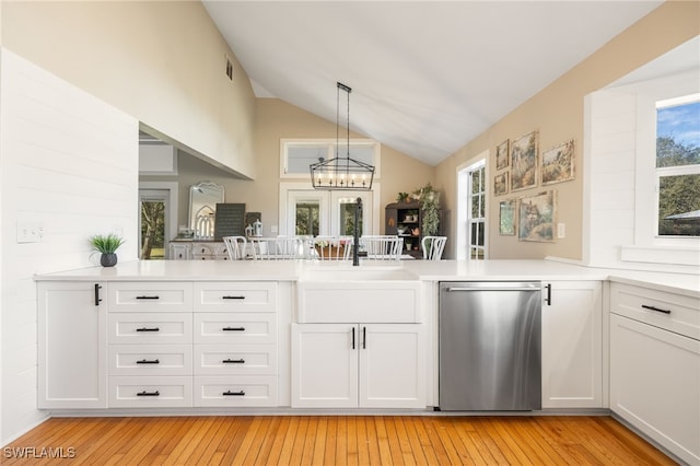 kitchen with white cabinetry, hanging light fixtures, and kitchen peninsula