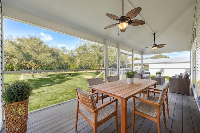 sunroom with lofted ceiling and ceiling fan