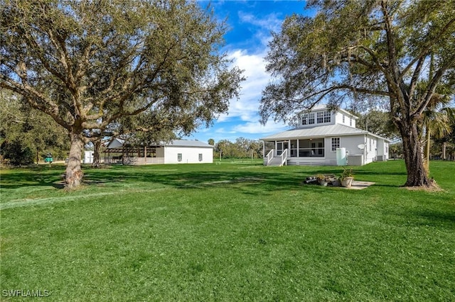 view of yard featuring a sunroom