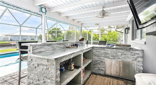 view of patio / terrace with exterior kitchen and an outdoor bar