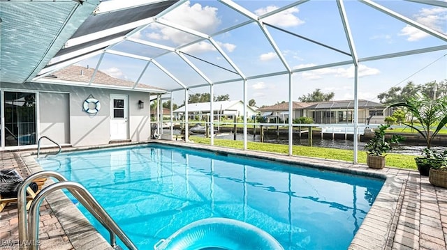 view of swimming pool featuring a water view, a patio area, and glass enclosure