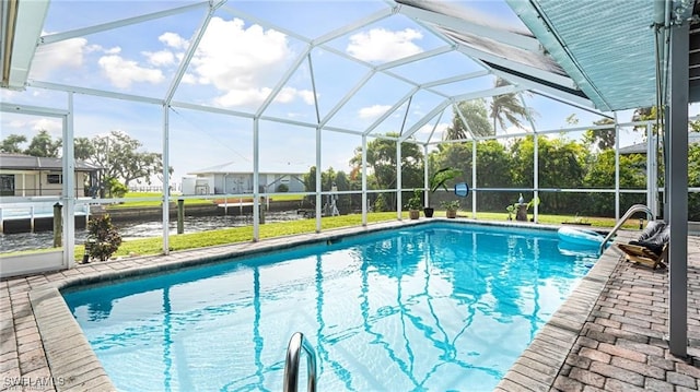 view of swimming pool featuring a patio area and glass enclosure