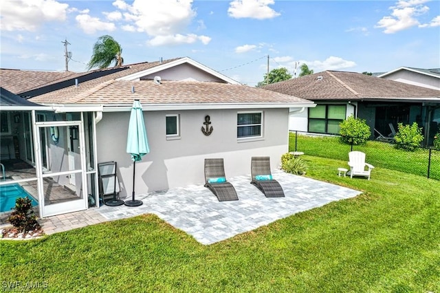 back of house with a patio area and a lawn