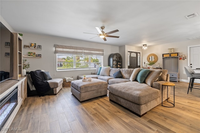 living room with hardwood / wood-style flooring and ceiling fan