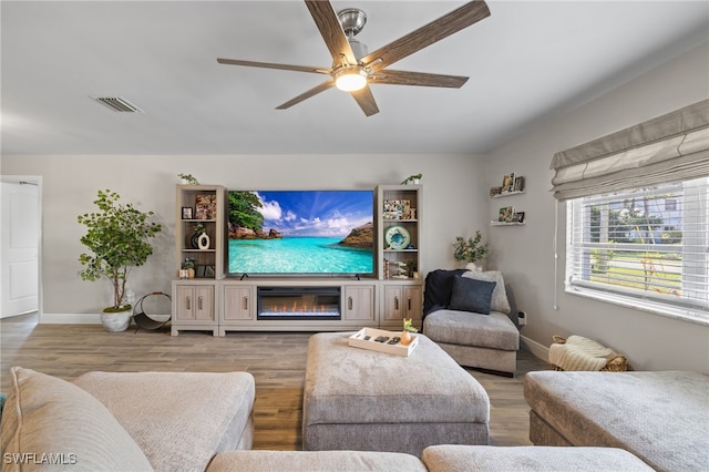 living room featuring ceiling fan and hardwood / wood-style floors