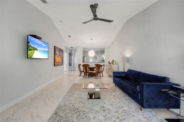 living room with ceiling fan with notable chandelier and high vaulted ceiling