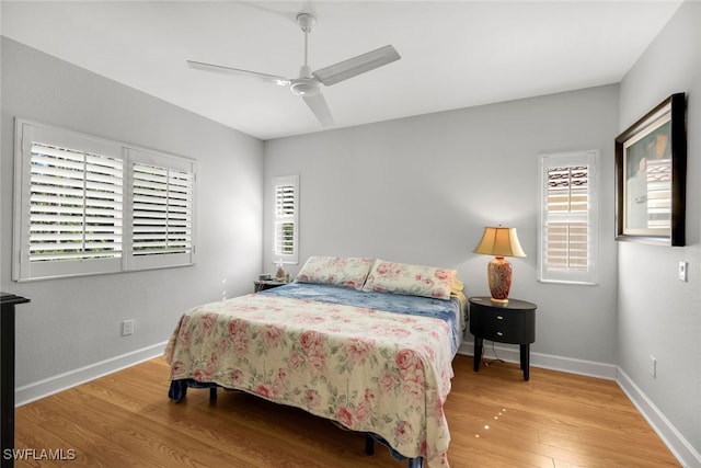 bedroom with ceiling fan and light wood-type flooring