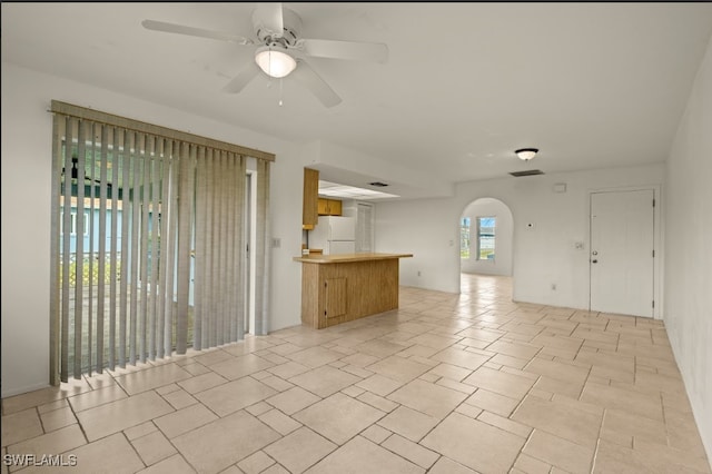 unfurnished living room featuring ceiling fan