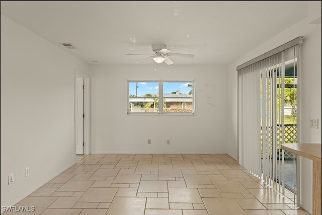 unfurnished room with a wealth of natural light and ceiling fan