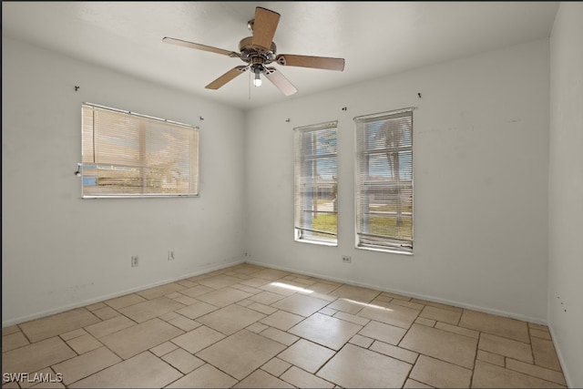 spare room featuring plenty of natural light and ceiling fan