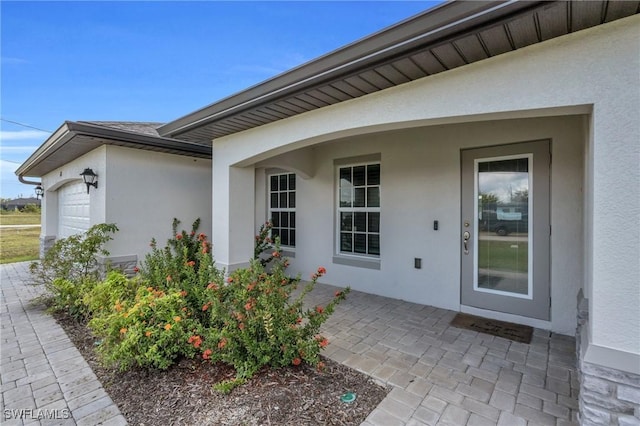 view of exterior entry with a garage