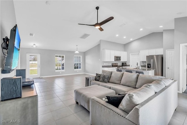 tiled living room featuring high vaulted ceiling and ceiling fan