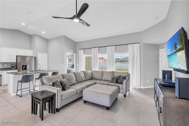 tiled living room featuring sink, vaulted ceiling, and ceiling fan