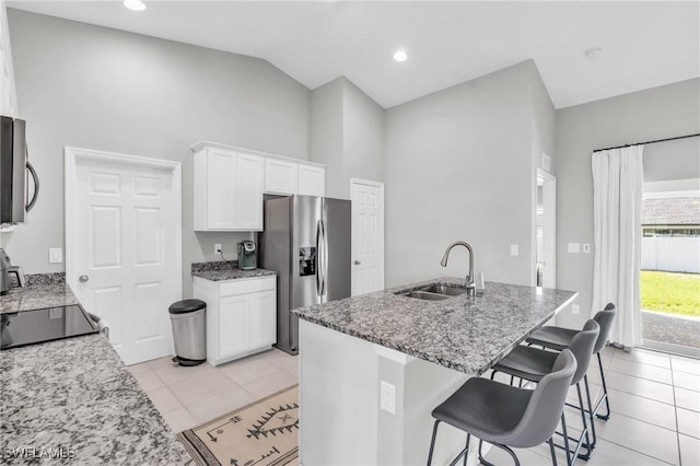 kitchen with white cabinetry, appliances with stainless steel finishes, light stone countertops, and sink