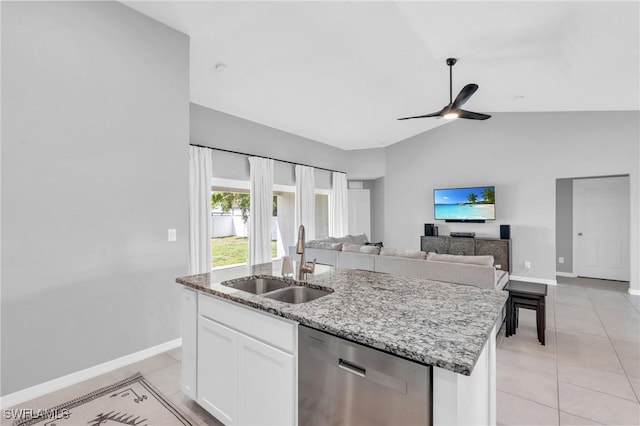 kitchen featuring sink, white cabinetry, a center island with sink, light tile patterned flooring, and stainless steel dishwasher