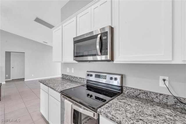 kitchen featuring light stone countertops, white cabinetry, and appliances with stainless steel finishes