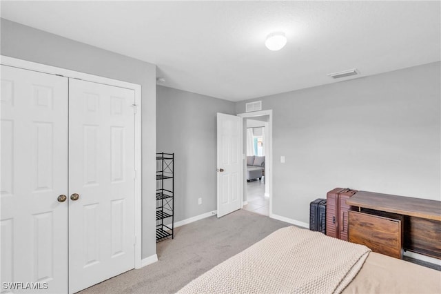 bedroom with light colored carpet and a closet