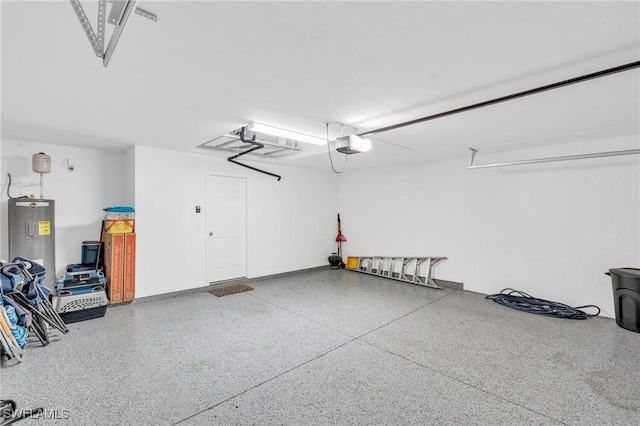 garage featuring a garage door opener and water heater