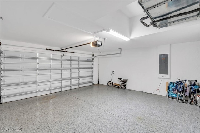 garage with a garage door opener and electric panel