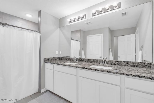 bathroom with vanity, tile patterned flooring, and curtained shower