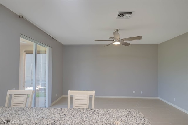 unfurnished room with ceiling fan and plenty of natural light