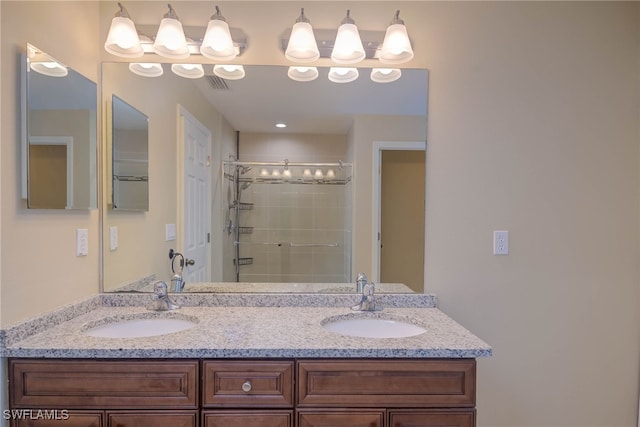 bathroom with vanity and a shower with shower door