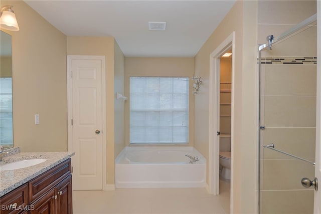 bathroom with vanity, toilet, a bathing tub, and tile patterned flooring