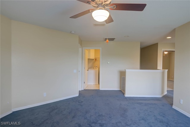 carpeted empty room with washer / dryer and ceiling fan