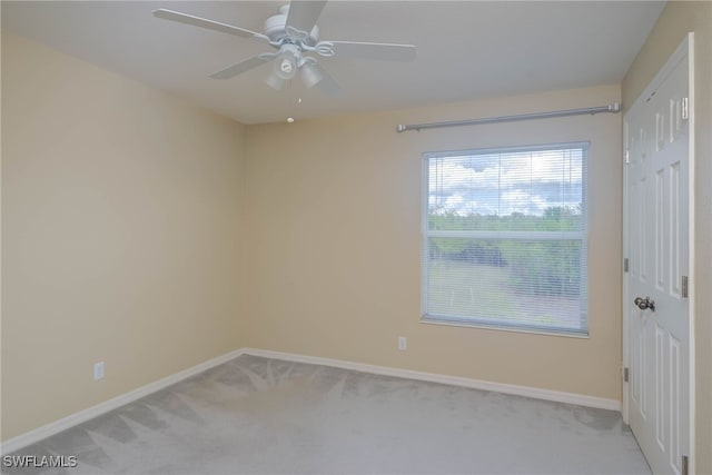 carpeted empty room featuring ceiling fan