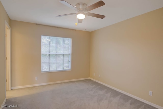 empty room with ceiling fan and light colored carpet