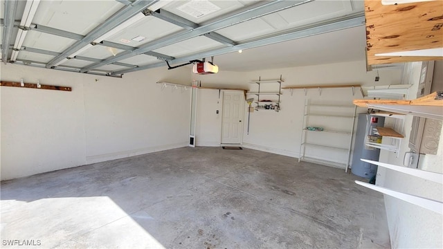 garage with a garage door opener and electric water heater