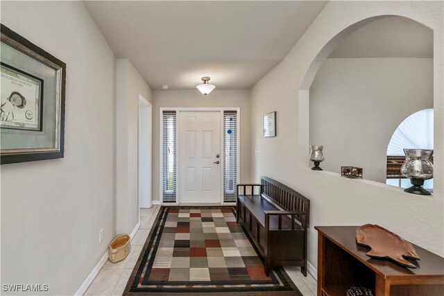 tiled foyer entrance with a wealth of natural light