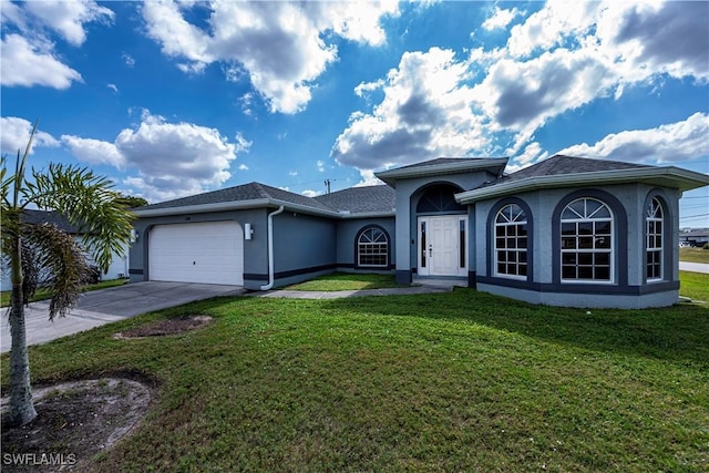 ranch-style house with a front yard, concrete driveway, an attached garage, and stucco siding